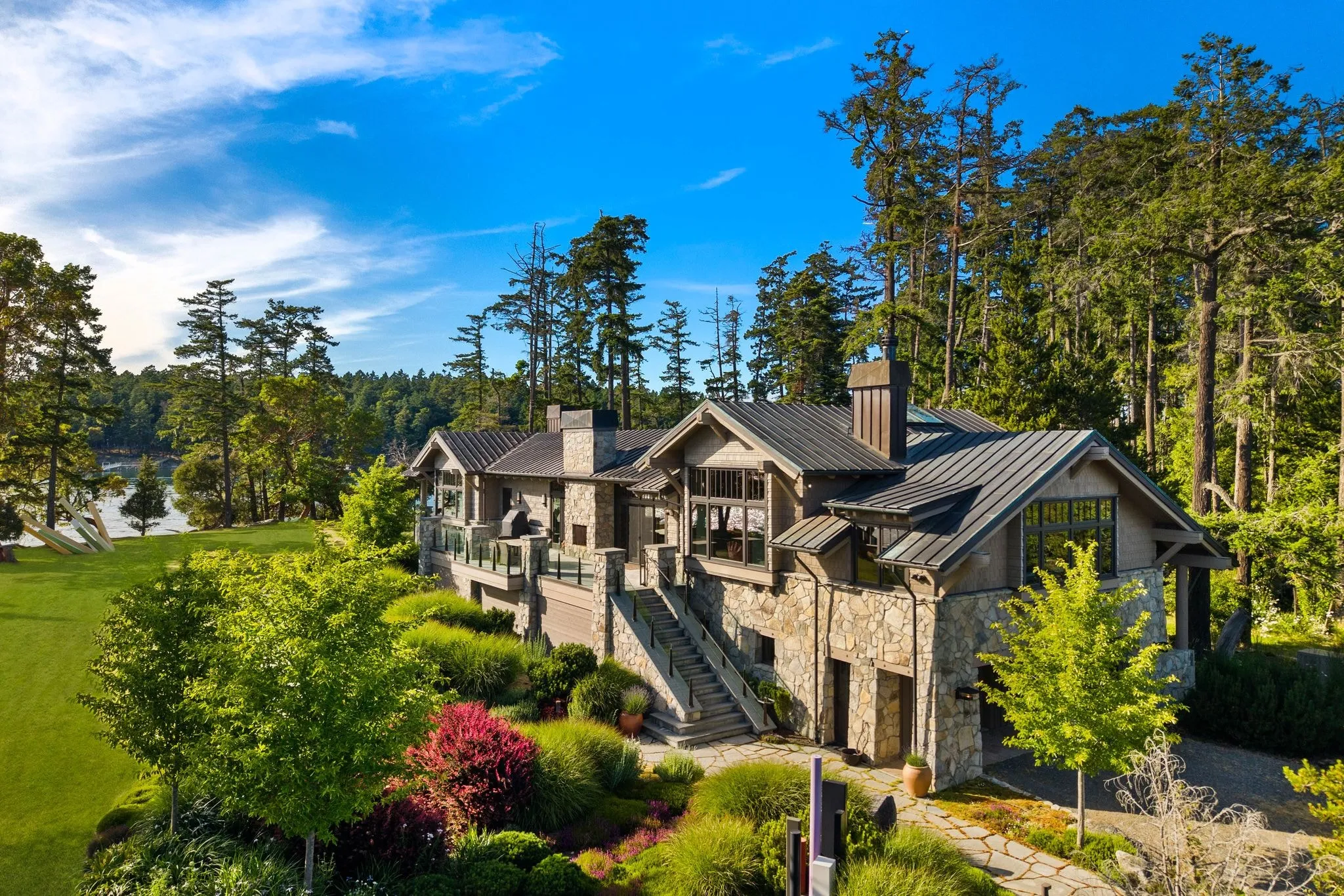 Aerial photograph of a Pacific Northwest home surrounded by evergreens, taken by ACRE Seattle
