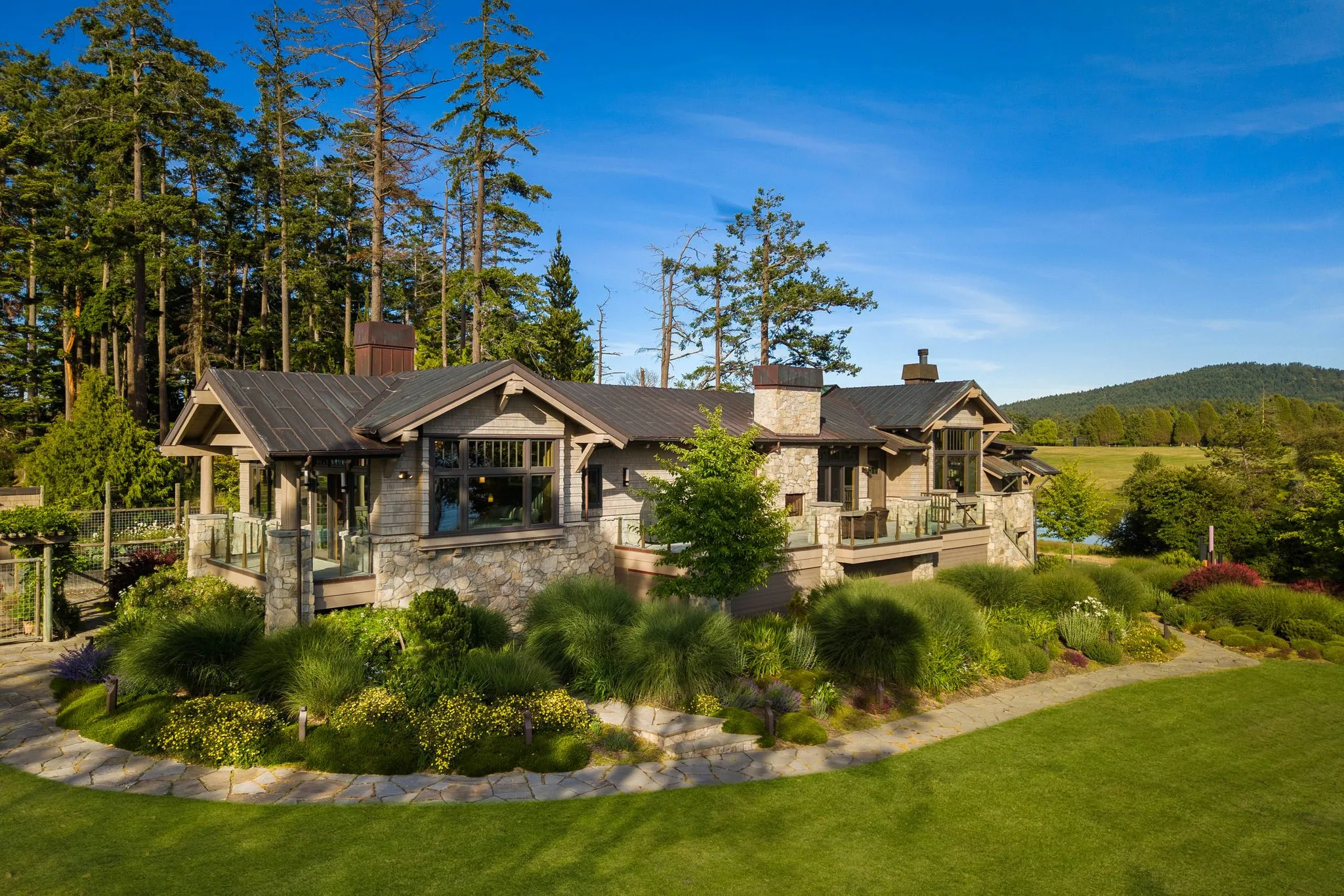 Aerial photograph of an estate set in forested acreage, shot by ACRE Seattle