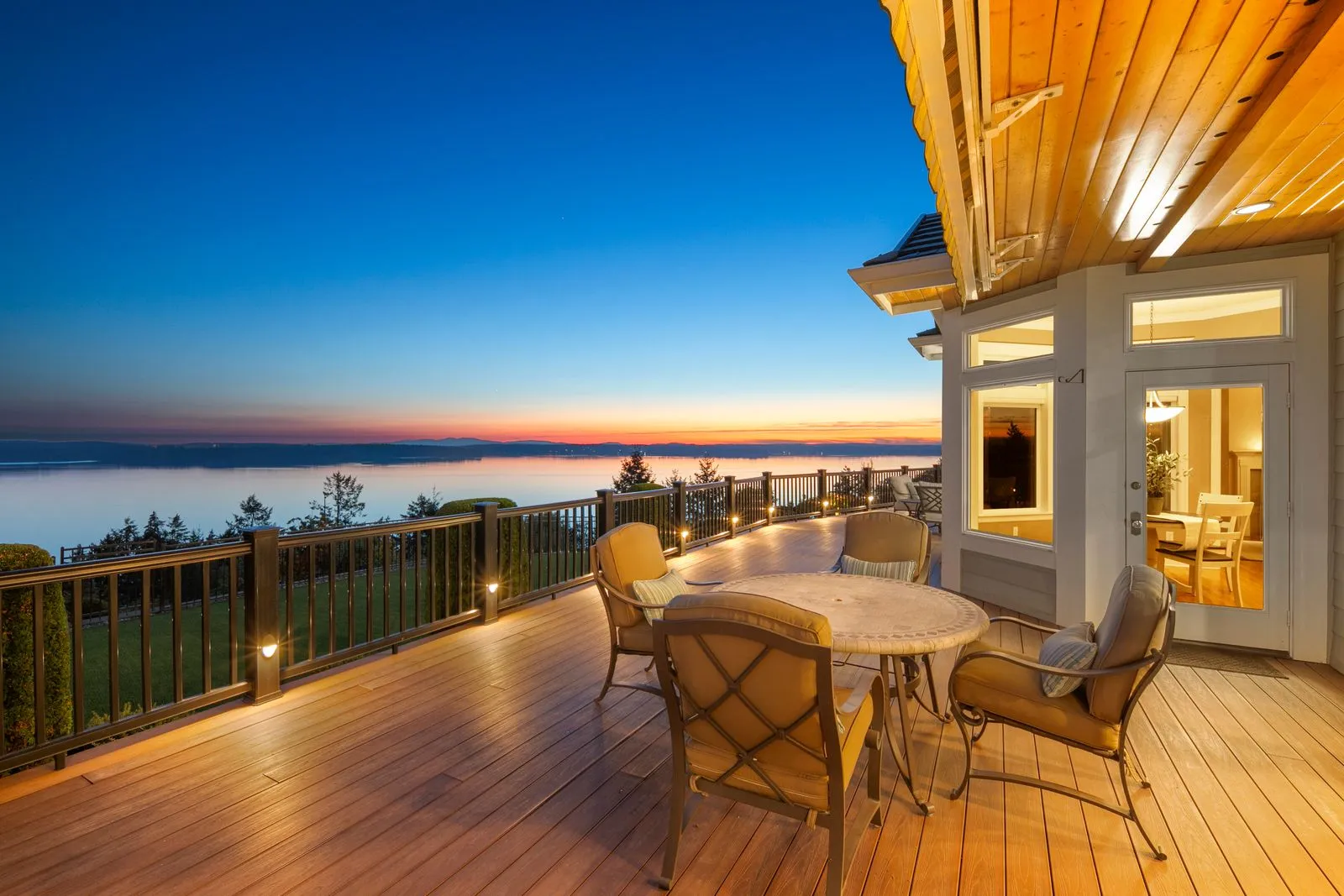 Dining area overlooking the water at sunset in a home ACRE Seattle filmed for a cinematic property video