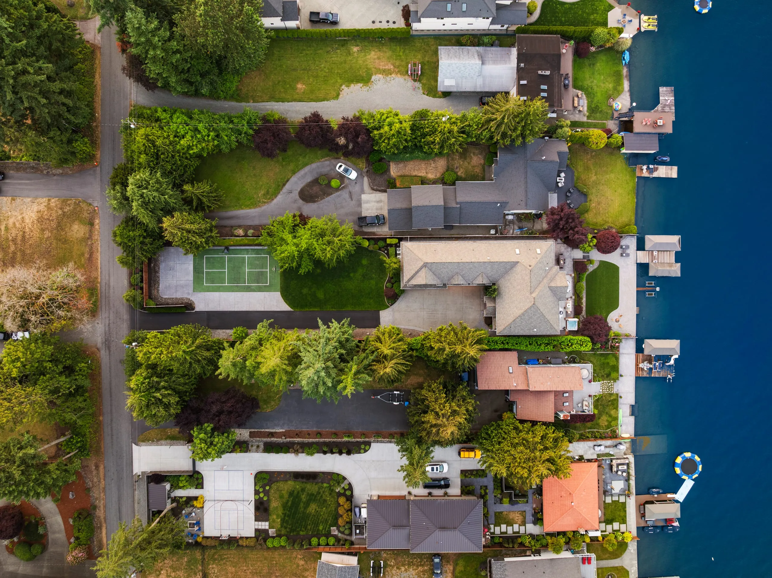 Residential waterfront property directly overhead by drone