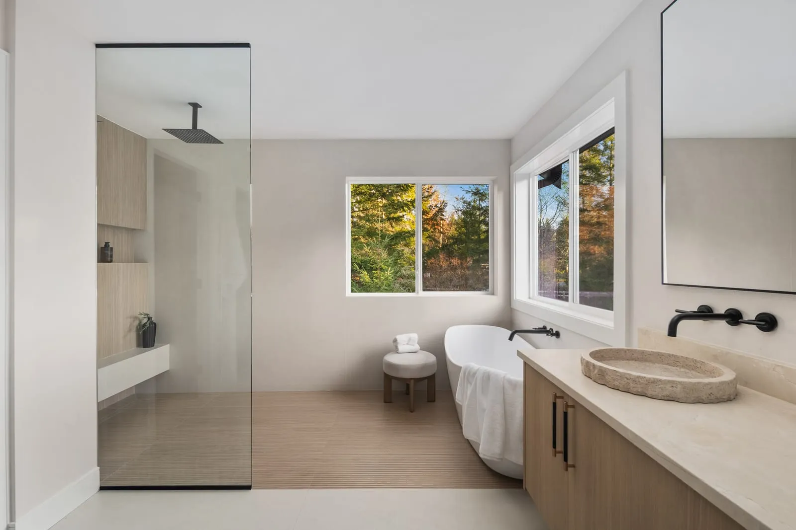 Bathroom lit by a window beside the vanity