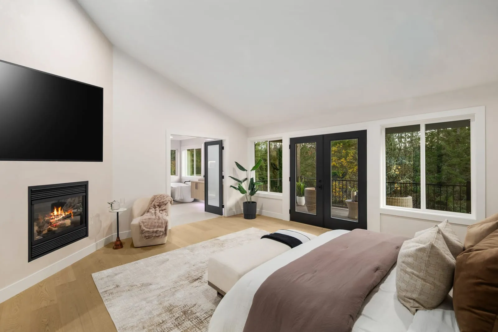 Bedroom with a fireplace and windows onto the garden
