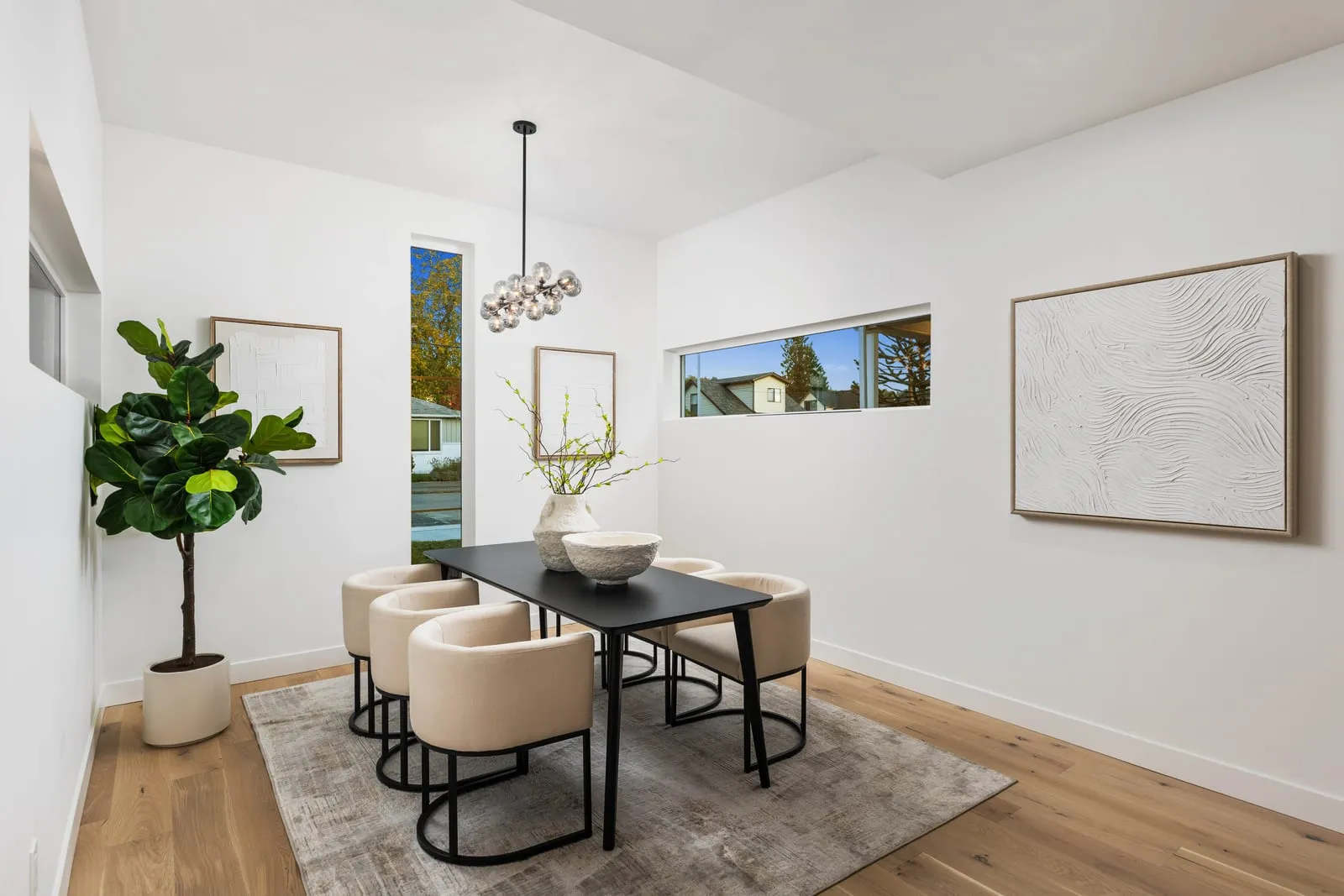Modern dining room with a long table and framed art