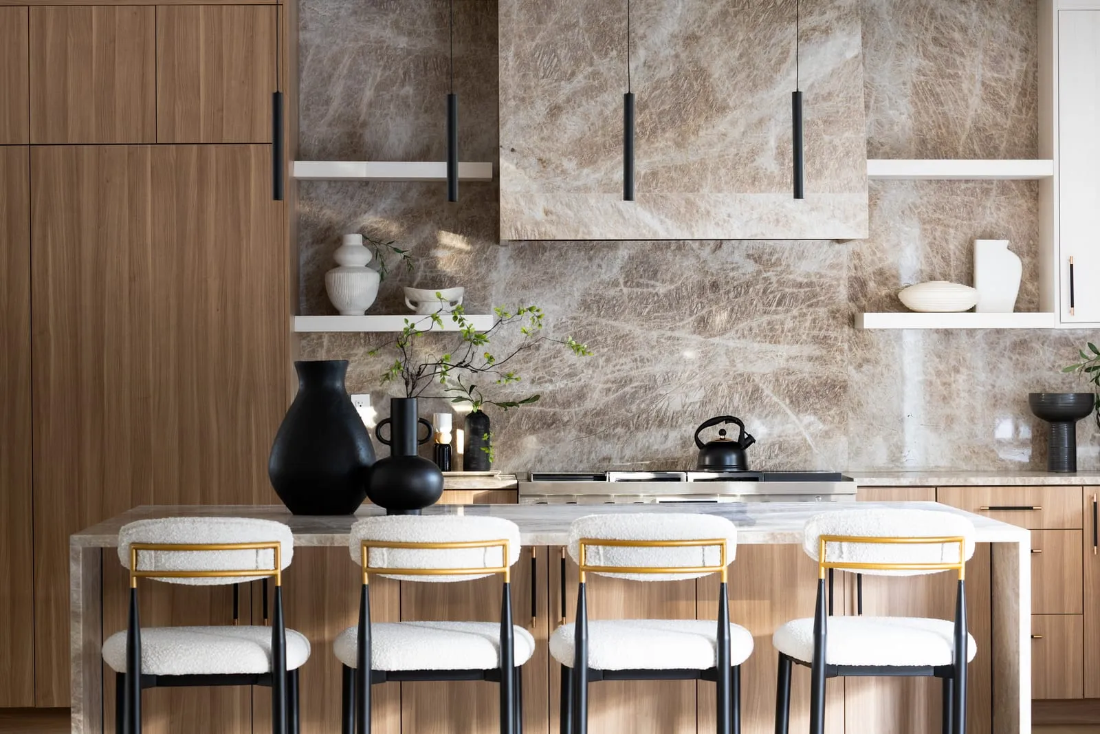 Kitchen with a full marble backsplash and integrated cabinetry