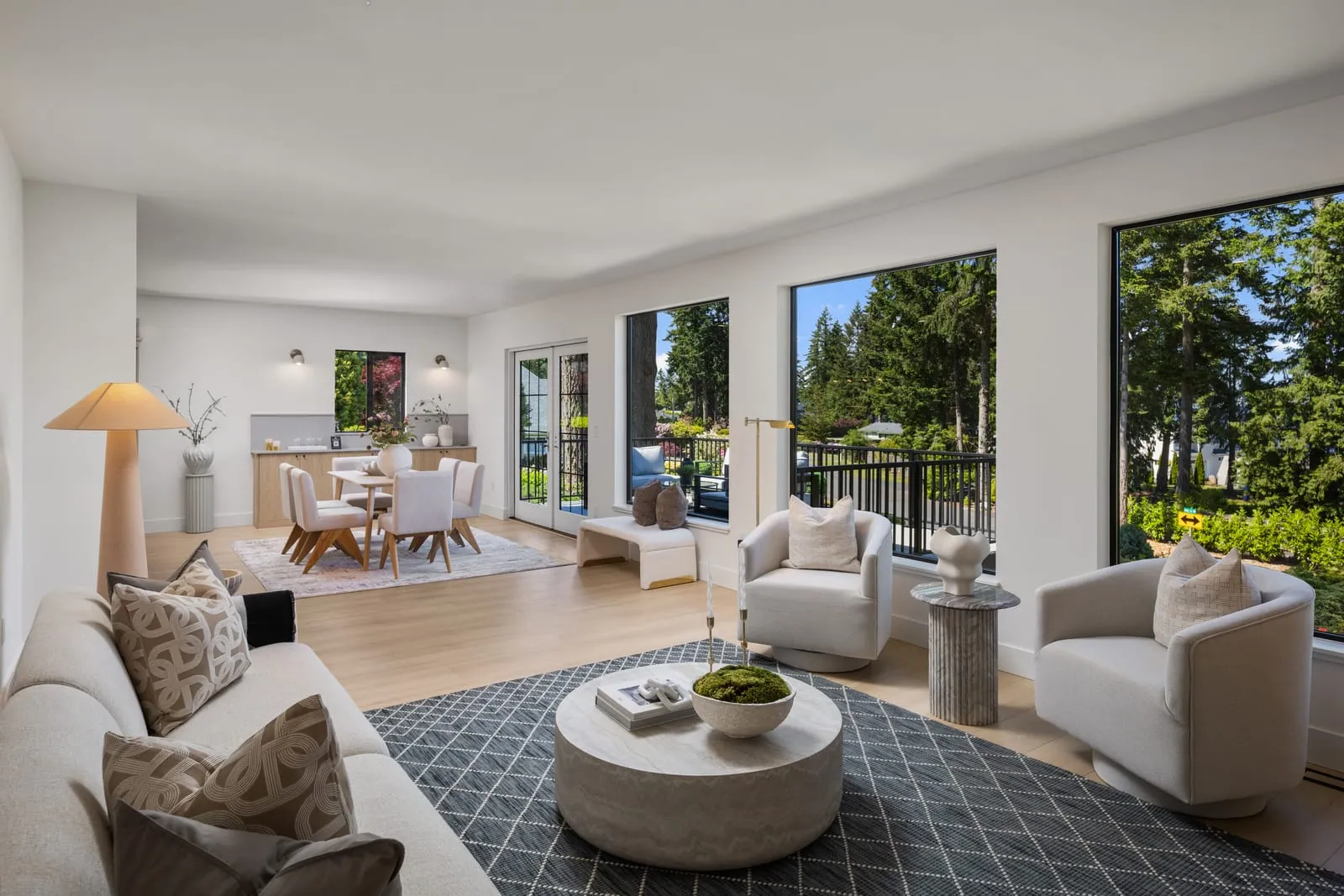 Open living and dining space lit by a bank of windows