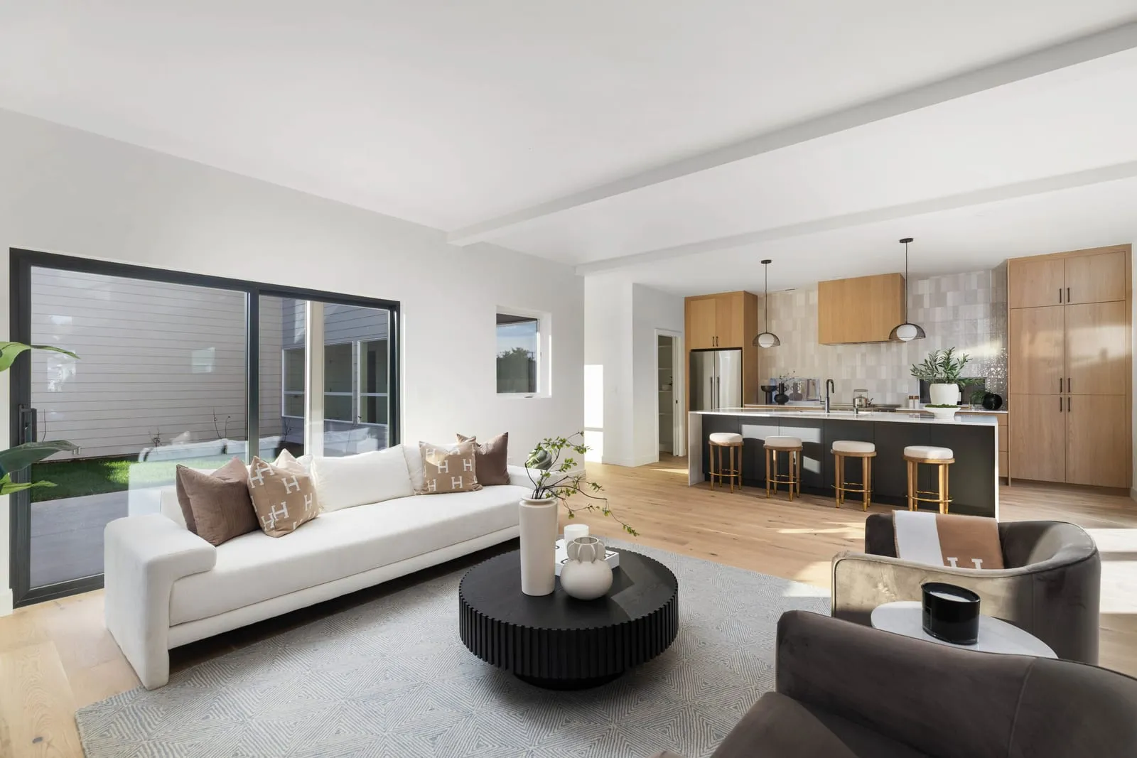 Open-plan living and kitchen under a vaulted ceiling