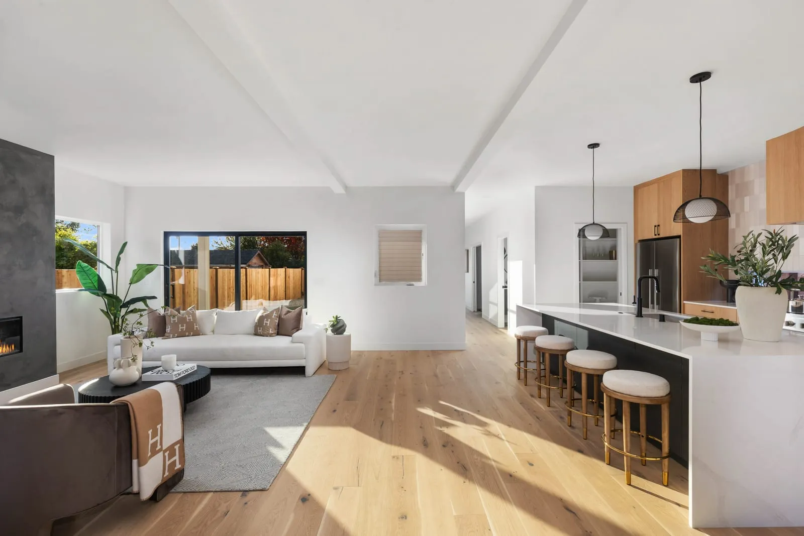 Open-plan living and kitchen on pale wood floors