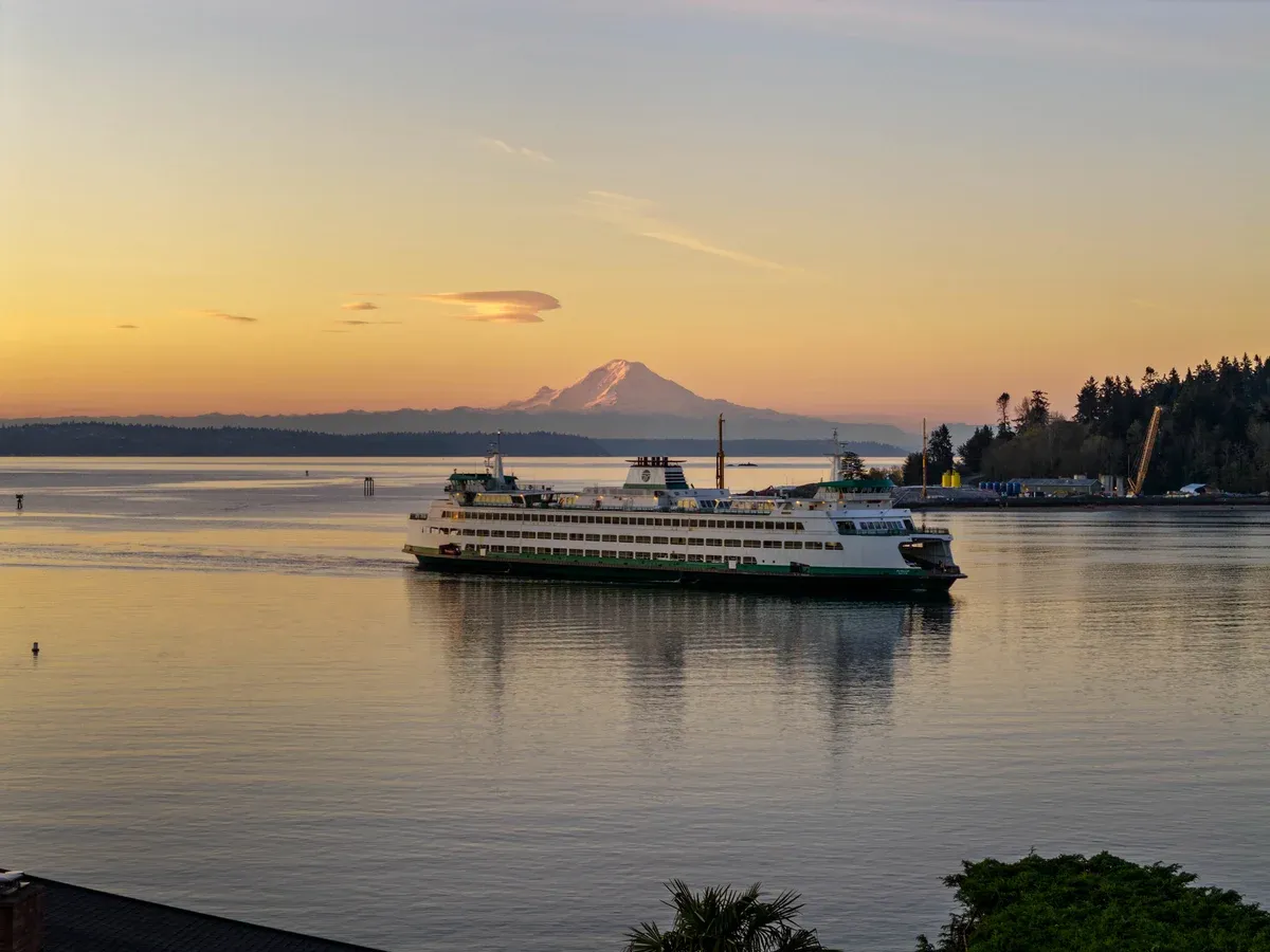 Ferry crossing the water at sunrise, photographed by RE-MEDIA