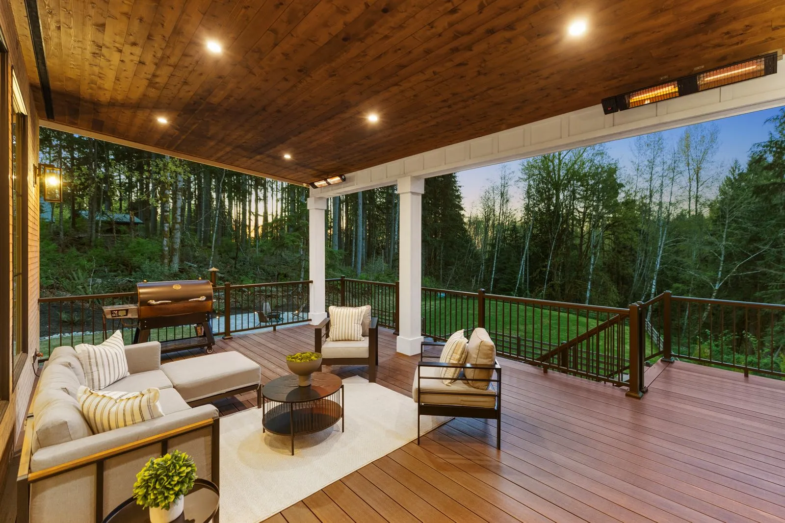 Covered outdoor living space photographed at twilight