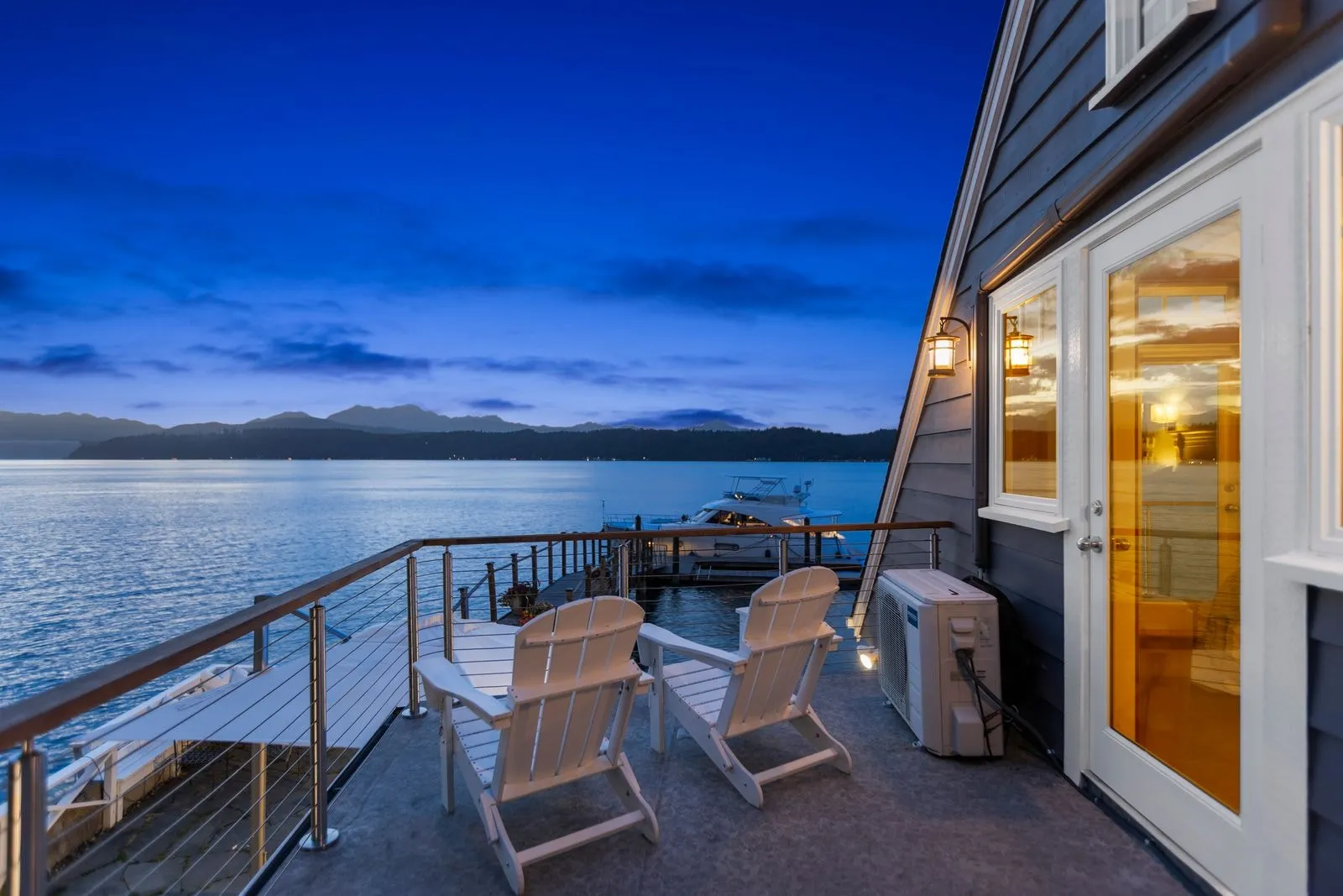 Deck with a water view photographed at dusk by ACRE Seattle
