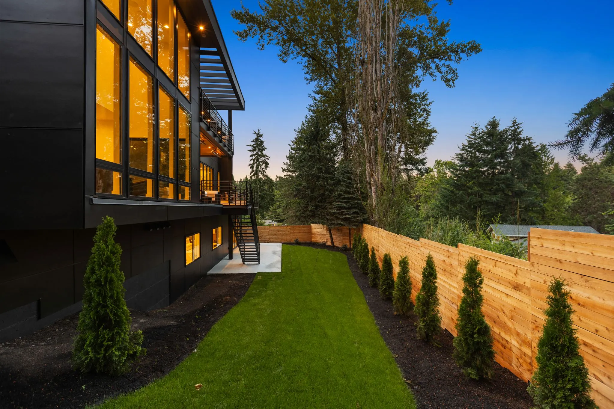 Side elevation and lawn photographed at dusk by ACRE Seattle
